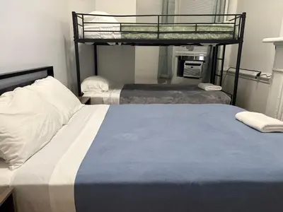 a bedroom with two beds and a bunk bed at The Midtown Ninth Manhattan Times Square in New York