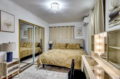 a bedroom with two beds and a mirror at Walk to Public Transit! Pet-Friendly Lodi Apt in Lodi