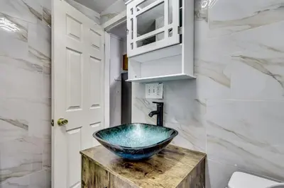 a bathroom with a bowl sink on a wooden counter at Walk to Public Transit! Pet-Friendly Lodi Apt in Lodi