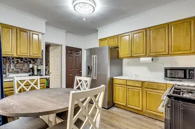 a kitchen with a table and a refrigerator at Walk to Public Transit! Pet-Friendly Lodi Apt in Lodi