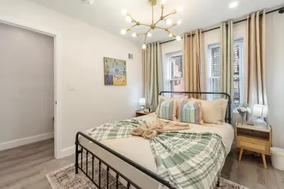 a bedroom with a bed and a window at Cozy 1BR level apartment w patio & workstation in Jersey City
