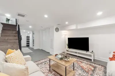 a living room with a couch and a tv at Holiday Home Brownstone City Stay 5BEDS, Private Dual Units in Jersey City