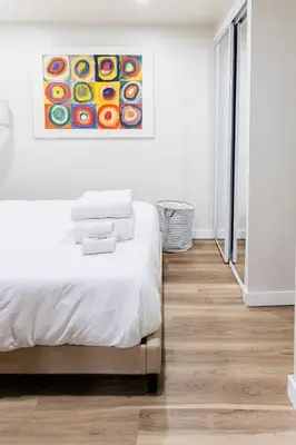 a bedroom with a bed and a painting on the wall at Cozy and Convenient Studio with 3 beds 10 Minutes to NYC in Union City