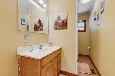 a bathroom with a sink and a mirror at Owls' Hollow in West Dover