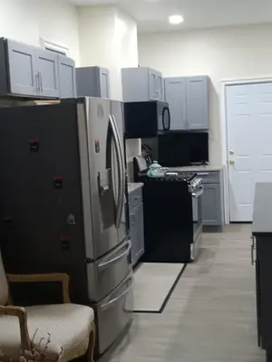 a kitchen with a refrigerator and a stove at Luxury private room bath WiFi in Troy