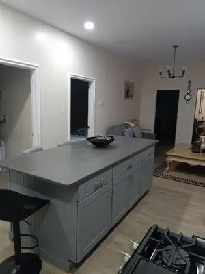 a kitchen with a large island in the middle of a room at Luxury private room bath WiFi in Troy
