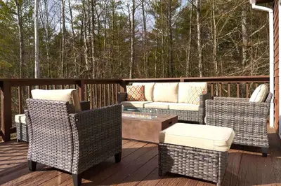 a patio with chairs and a couch on a deck at Secluded Catskills Cabin , Cozy and Private in Acra