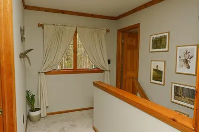 a room with a staircase and a window and a stair case at Secluded Catskills Cabin , Cozy and Private in Acra