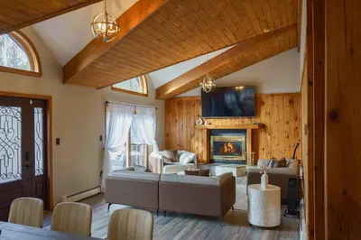a living room with a couch and a fireplace at Secluded Catskills Cabin , Cozy and Private in Acra