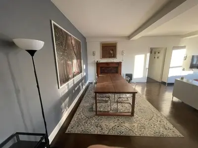 a living room with a table and a lamp at Manhattan Oasis in Peekskill