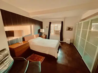 a bedroom with a bed and a couch in it at Manhattan Oasis in Peekskill