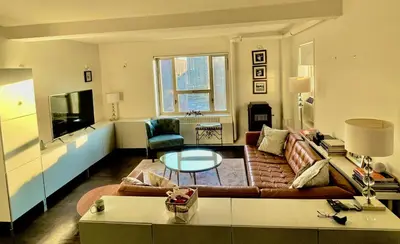 a living room with a couch and a table at Manhattan Oasis in Peekskill