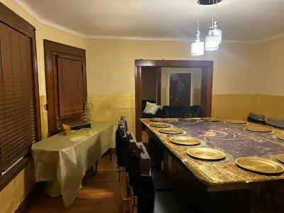 a dining room with a long table with plates on it at Credo Ok! Party Room in Bridgeport