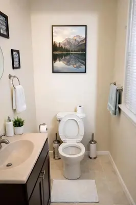 a bathroom with a toilet and a sink at Credo Ok! Party Room in Bridgeport