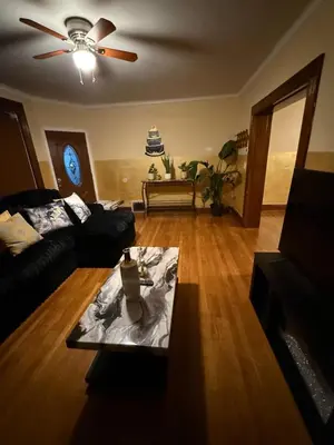 a living room with a couch and a ceiling fan at Credo Ok! Party Room in Bridgeport