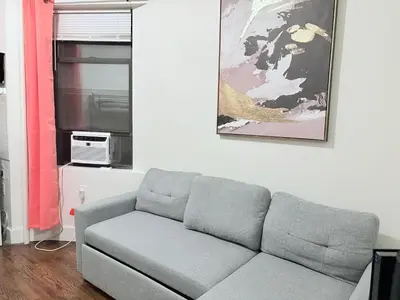 a living room with a couch and a picture on the wall at The W50 Metropolitan in New York