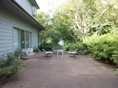 a patio with chairs and a table next to a house at Eve's Country Retreat