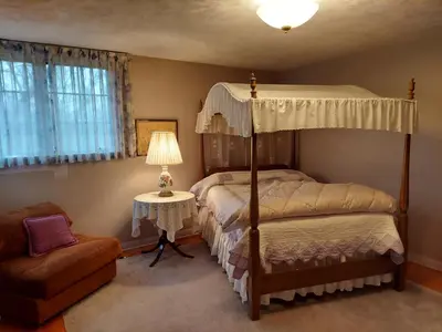 a bedroom with two bunk beds and a chair at Eve's Country Retreat