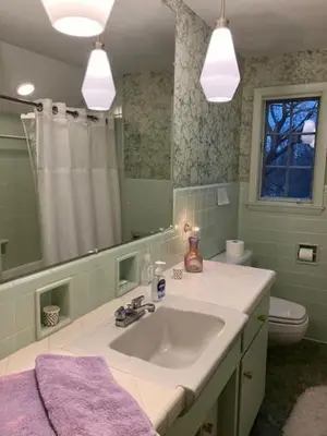 a bathroom with a sink and a toilet and a mirror at Eve's Country Retreat