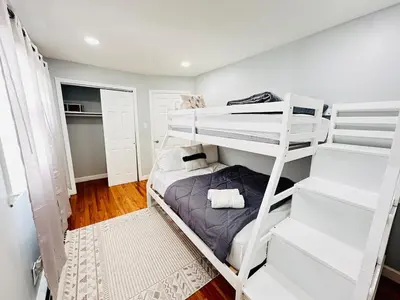 a bedroom with two bunk beds in a room at Lux NYC Stay 3Bed2Bath w parking in Jersey City