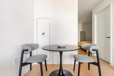 a table and four chairs in a room at Blueground South Williamsburg rooftop nr Domino Park NYC-2131 in Brooklyn