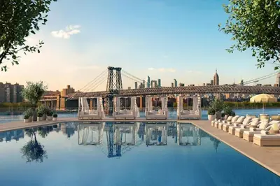 a swimming pool with a bridge in the background at Blueground South Williamsburg rooftop nr Domino Park NYC-2131 in Brooklyn