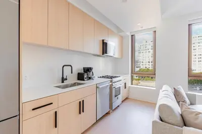 a kitchen with a sink and a stove at Blueground South Williamsburg rooftop nr Domino Park NYC-2131 in Brooklyn