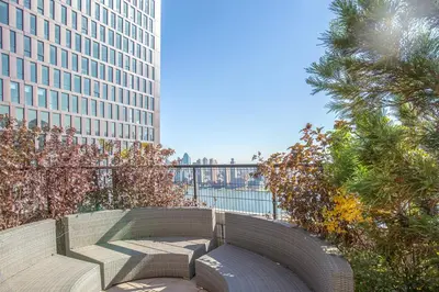 a bench in a park with a view of a building at Blueground Murray Hill fitness center nr East River NYC-695 in New York