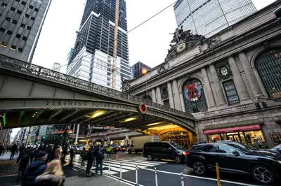 a bridge over a street in a city with cars at Blueground Murray Hill fitness center nr East River NYC-695 in New York