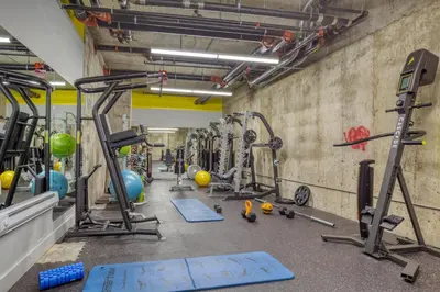 a gym with a bunch of equipment in a room at Blueground Williamsburg rooftop nr East River NYC-1992 in Brooklyn