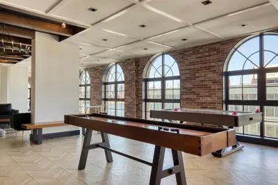 a pool table in a room with windows at Blueground Williamsburg rooftop nr East River NYC-1992 in Brooklyn