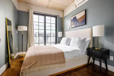 a bedroom with a large bed and a window at Blueground Williamsburg rooftop nr East River NYC-1992 in Brooklyn