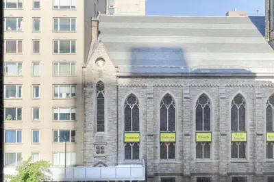 a building with a clock on the side of it at Blueground Carnegie Hill fitness center nr Central Park NYC-1967 in New York