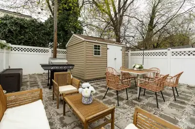a patio with a table and chairs and a grill at Chic 3BR-4BD-3Bath Oasis with Backyard Near NYC in Jersey City