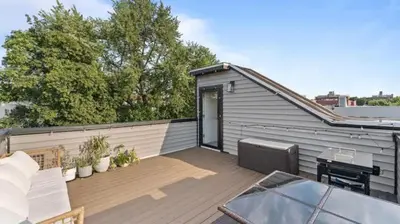 a backyard deck with a patio furniture and a shed at Elegant 2BR-2BA Spacious Escape with Rooftop Near NYC in Jersey City