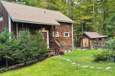 a small wooden house with a porch and a yard at Greer Court Retreat in Wilmington
