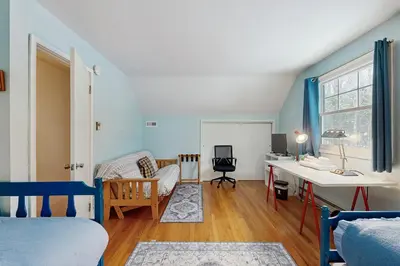 a bedroom with a bed and a desk in a room at Greer Court Retreat in Wilmington