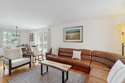 a living room with a brown leather couch and chairs at Greer Court Retreat in Wilmington