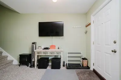 a living room with a tv on a wall at Cozy Townhouse Near Hunter Mountain in Tannersville