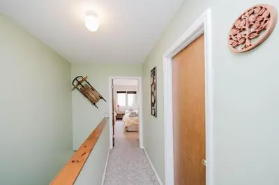 a hallway with a door leading to a bedroom at Cozy Townhouse Near Hunter Mountain in Tannersville