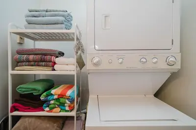 a laundry room with a washing machine and towels at Cozy Townhouse Near Hunter Mountain in Tannersville