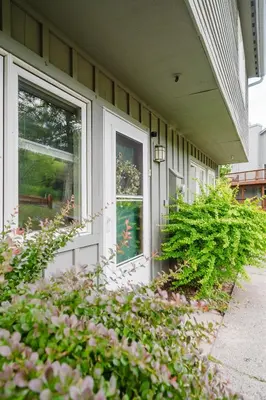 a house with a white door and a window at Cozy Townhouse Near Hunter Mountain in Tannersville