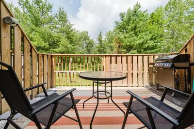 a patio with a table and chairs and a grill at Cozy Townhouse Near Hunter Mountain in Tannersville