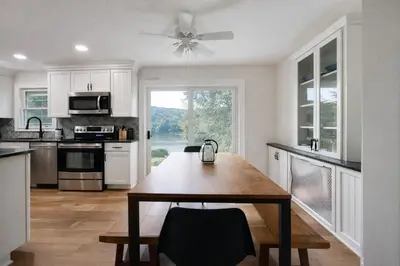 a kitchen with a table and a ceiling fan at Lakefront House 30 Min to NYC & MetLife Stadium