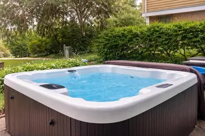 a large hot tub in a yard with at Lakefront House 30 Min to NYC & MetLife Stadium