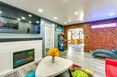 a living room with a fireplace and a couch at Walk to Shops, Parks and Restaurants Teaneck Escape in Teaneck