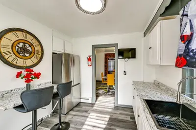 a kitchen with a large clock on the wall at Walk to Shops, Parks and Restaurants Teaneck Escape in Teaneck
