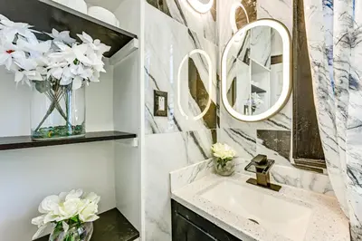 a bathroom with a sink and mirrors on the wall at Walk to Shops, Parks and Restaurants Teaneck Escape in Teaneck