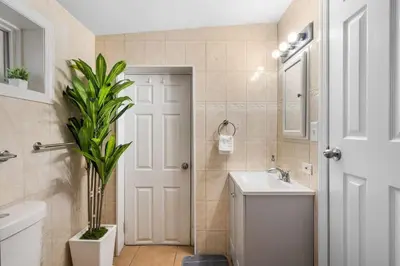 a bathroom with a sink and a toilet and a mirror at Queen Bedroom w Ensuite Bathroom - Mins from NYC in Jersey City