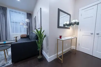 a living room with a couch and a table at Brand New 3BR 2BA next to Central Park, elevator in New York
